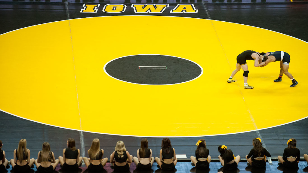 two wrestlers on gold IOWA mat
