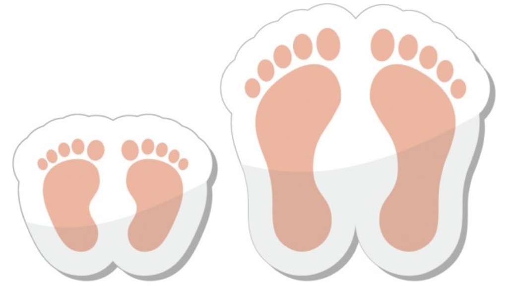 Illustration of baby feet next to an adult woman&#039;s feet, Image Credit: RedKoala / Shutterstock