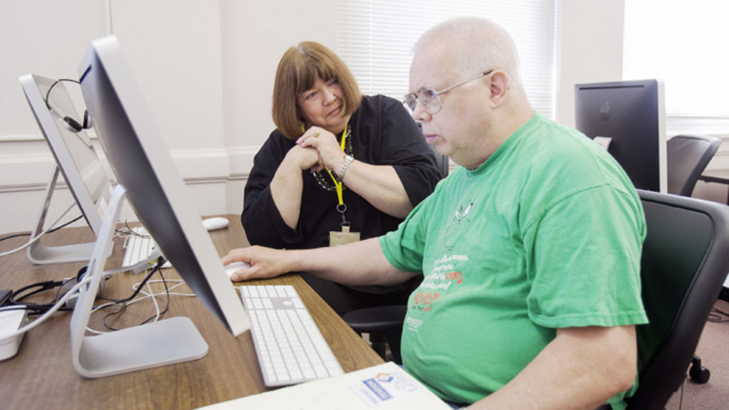 Dolores Ratcliff of Iowa City (left) guides Mike Bray of Iowa City during a computer mentoring session at the Iowa City Senior Center on Wednesday, June 19, 2013, in Iowa City. Ratcliff is a volunteer mentor at the center, teaching seniors one-on-one how 