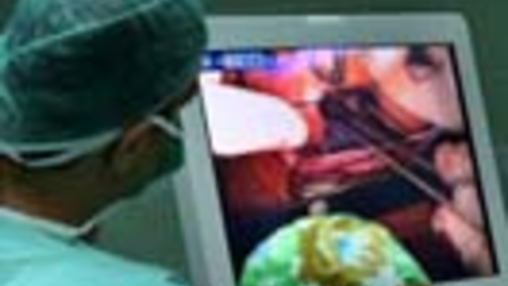 Surgeons monitor a procedure remotely
