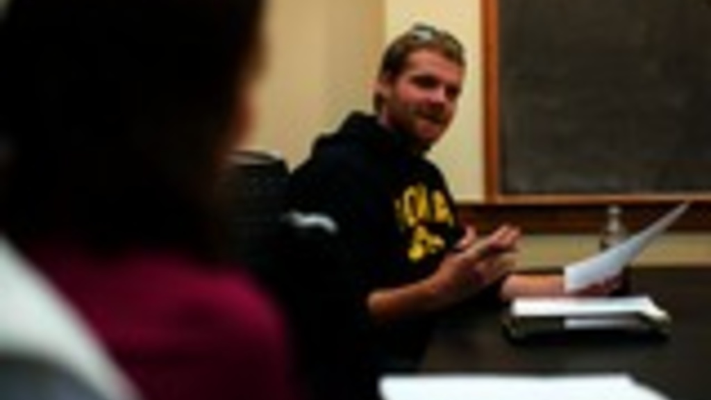 This photo taken Oct. 15, 2012 shows University of Iowa senior and Afghanistan veteran Dan Tallon of Davenport, Iowa, right, talking about the Korean war veteran he interviewed for a class project during his Life After War: Post-Deployment Issues class at