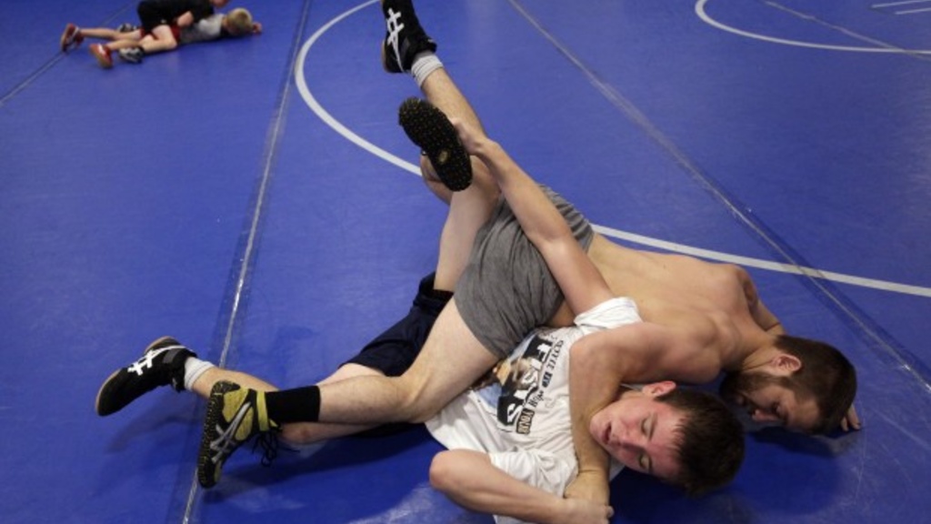 University of Iowa wrestler Josh Dziewa pins Dylan Hall, 16, during a wrestling camp for youth at Rapid City Stevens High School.