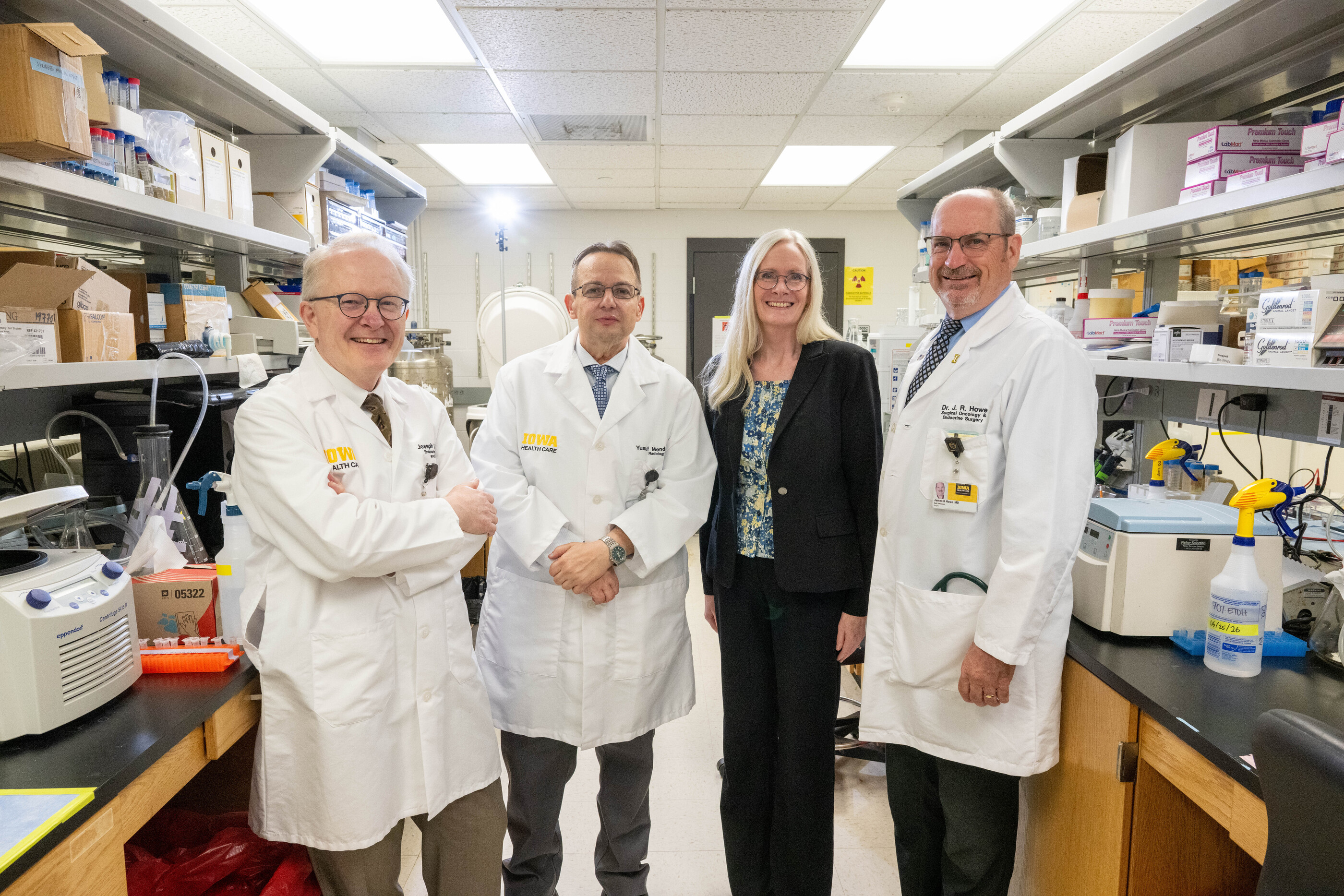 A group of four researchers pose in a lab