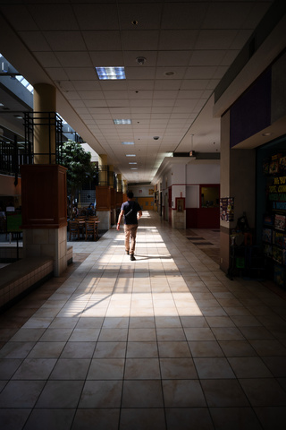 A person walking down a corridor in Old Capitol Town Center