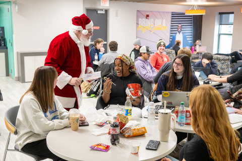 Patrick Johanns speaking with students dressed as Santa