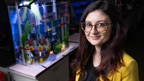 Caterina Lamuta standing near a small aquarium