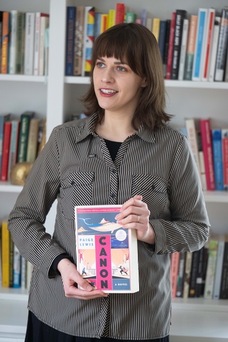 Author Paige Lewis holds a copy of their new book, Canon