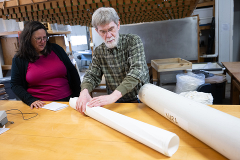 UI Center for the book staff roll large sheets of paper.