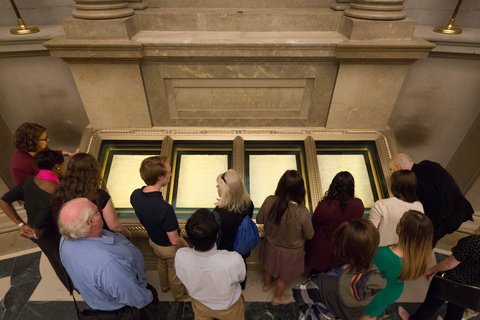 A group of visitors visits the Declaration of Independence at the National Rotunda