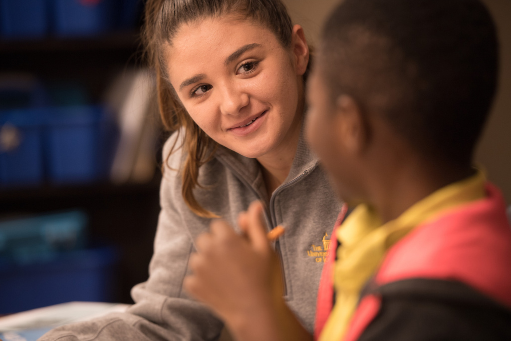 University of Iowa College of Education student working with a youth at a local elementary school