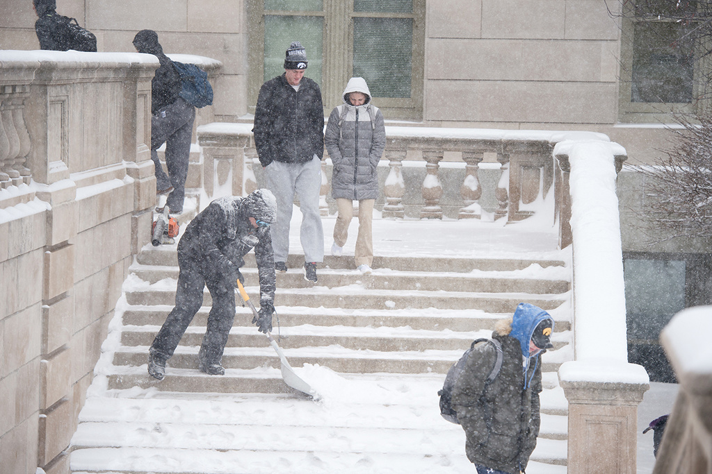 landscape services staff clearing snow