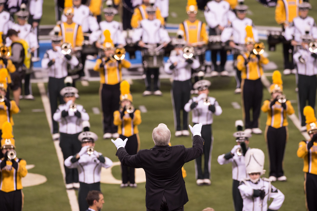 Kevin Kastens conducts the Iowa and Michigan State bands