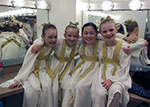 four young girls dressed as angels in dressing room