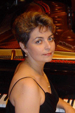ksenia nosikova sitting at piano