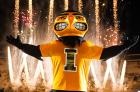 UI mascot Herky on stage with fireworks in the background