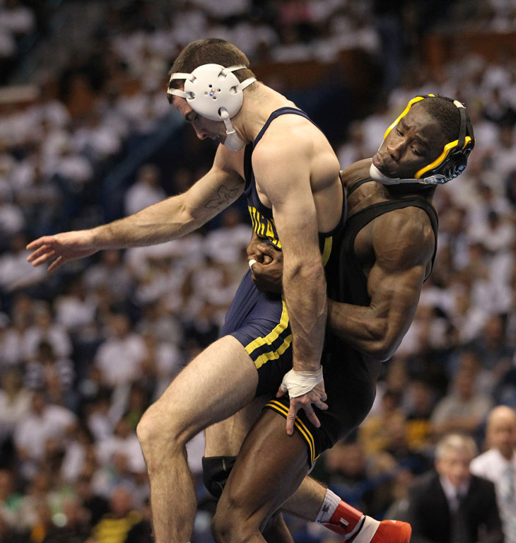 Montell Marion wrestles with Michigan's Kellen Russell.