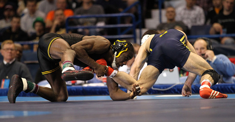 Montell Marion wrestles with Michigan's Kellen Russell