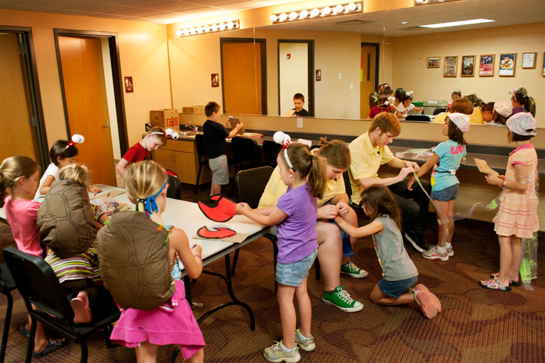 Participants in the Osage Summer Theatre Program get into costume before a dress rehearsal.