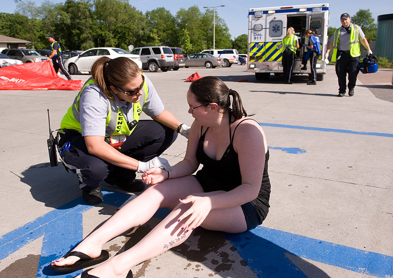 A "victim" is examined by an EMT.