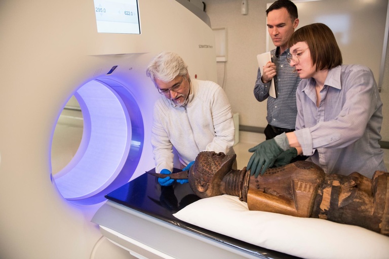 researchers load artwork into ct scanner