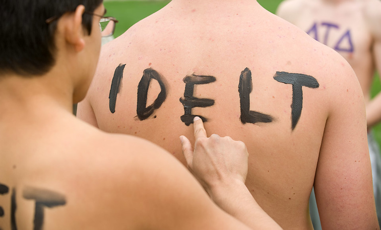 Nathan Chavez writes delt on the back of Carl Schickerling.
