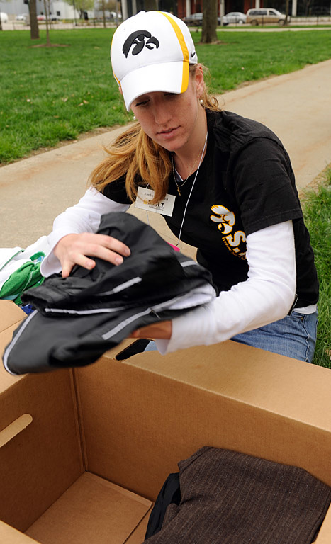 Kimberley Reed puts donated clothing into a box.