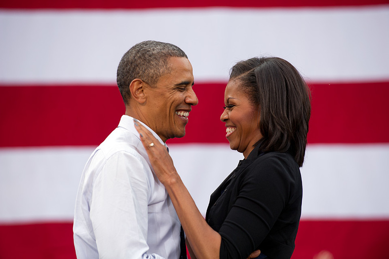 President Barack Obama and first lady Michelle Obama greet each other on stage
