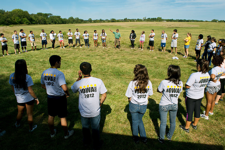 Students form a circle at the High Adventure Challenge Course during a team-building exercise.