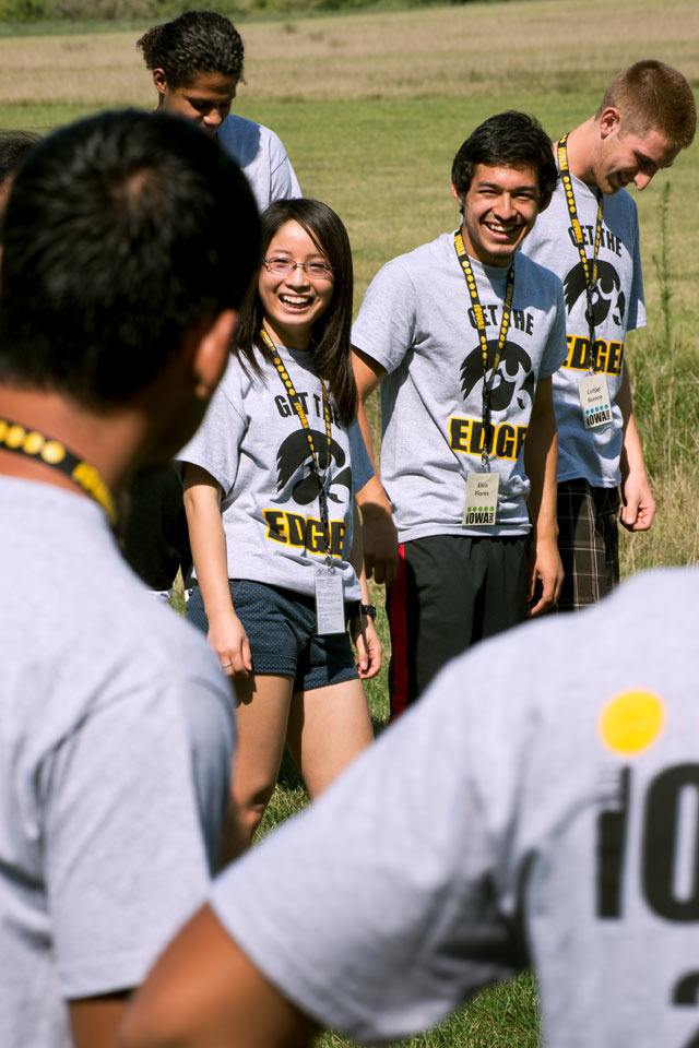 A group of Iowa Edge students laugh during a Challenge Course exercise.