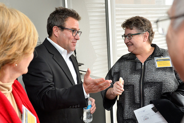 Mark Ginsberg, president of M.C. Ginsberg Objects of Art, chats with State Rep. Mary Mascher.