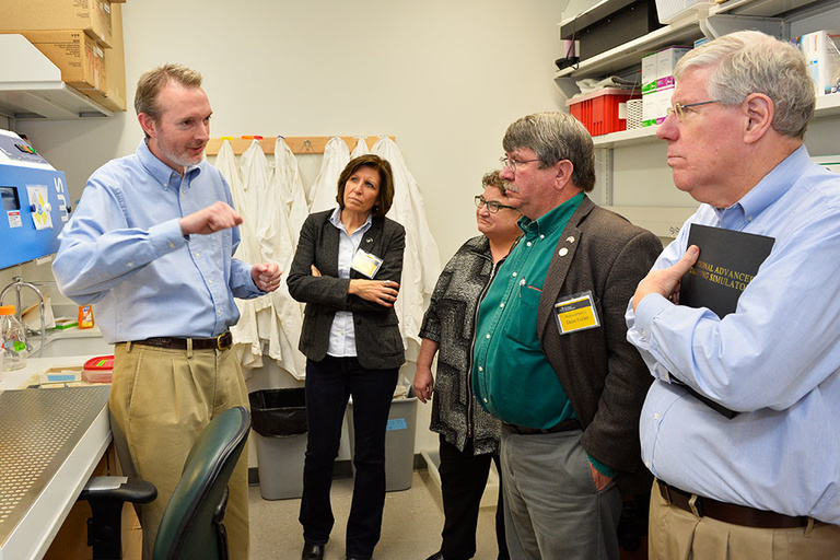 Robert Mullins, UI Professor of Ophthalmology and Visual Sciences (left), speaks with Sen. Rita Hart, Rep. Mary Mascher, Rep. Dean Fisher and Sen. Bob Dvorsky during a visit to the Wynn Institute for Vision Research. 