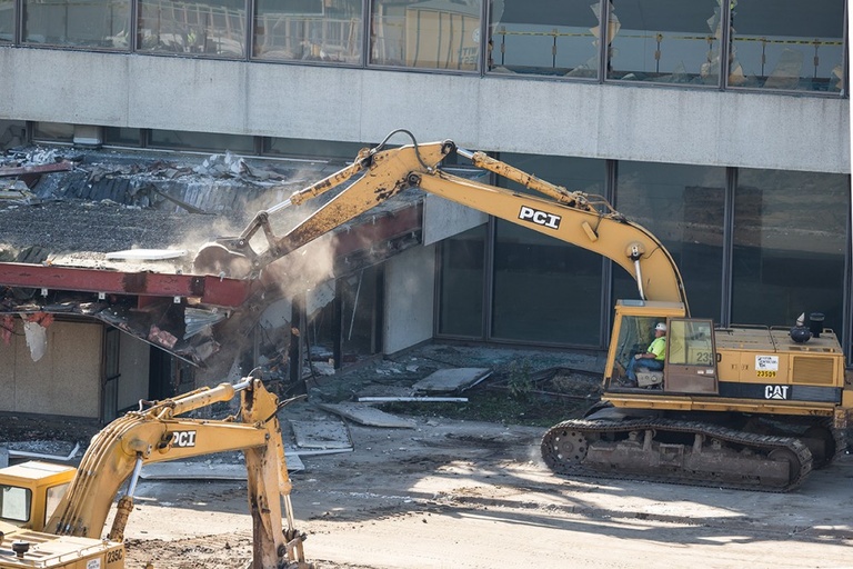 An excavator smashes into a building