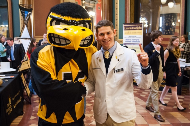 UI student poses with Herky in the Capitol.