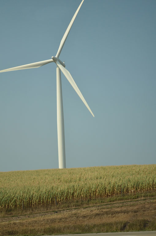 A photo of a wind turbine with just a few of the blades visible