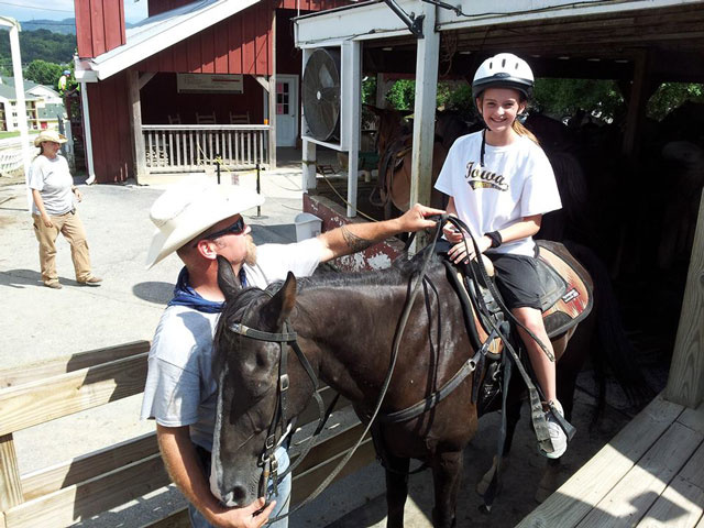 young girl riding a horse