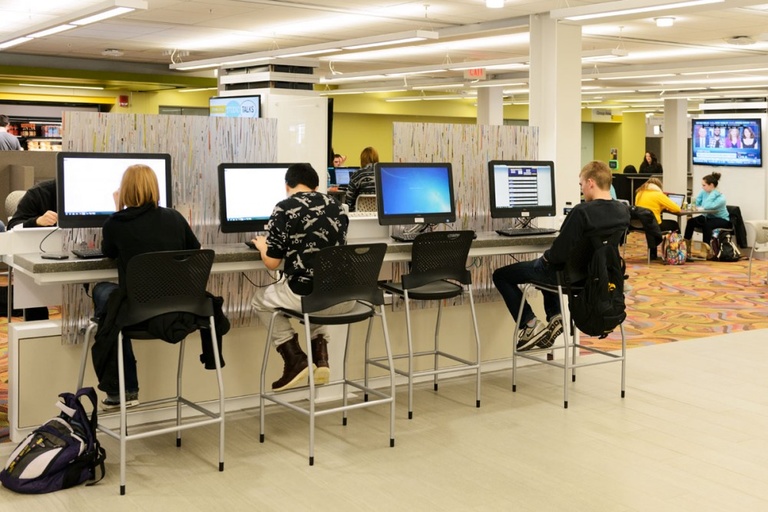Students at desktop computers in the Main Library Learning Commons.