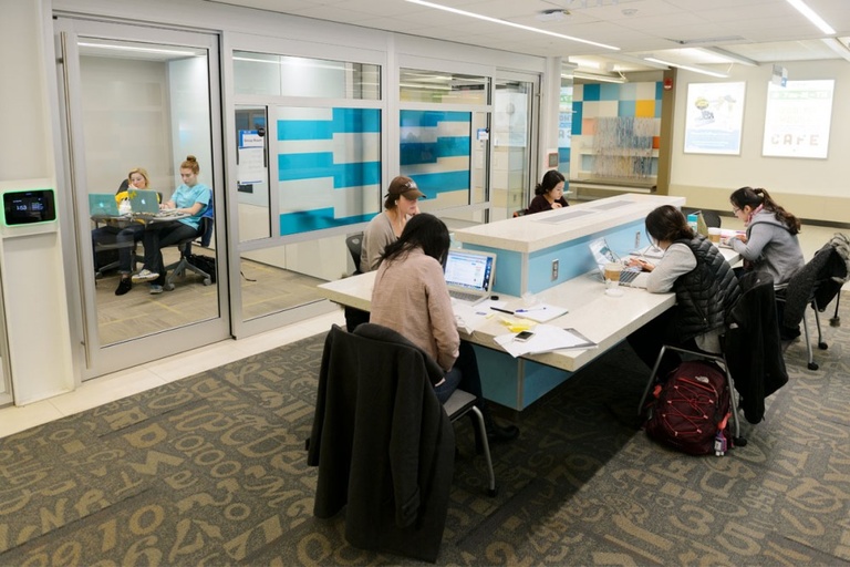 Students using a group study room at the Main Library Learning Commons.