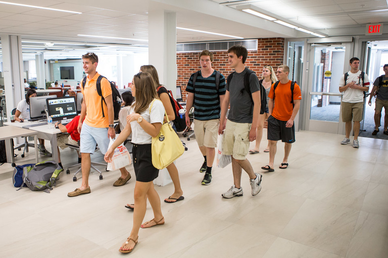 People walking through the Learning Commons lobby.
