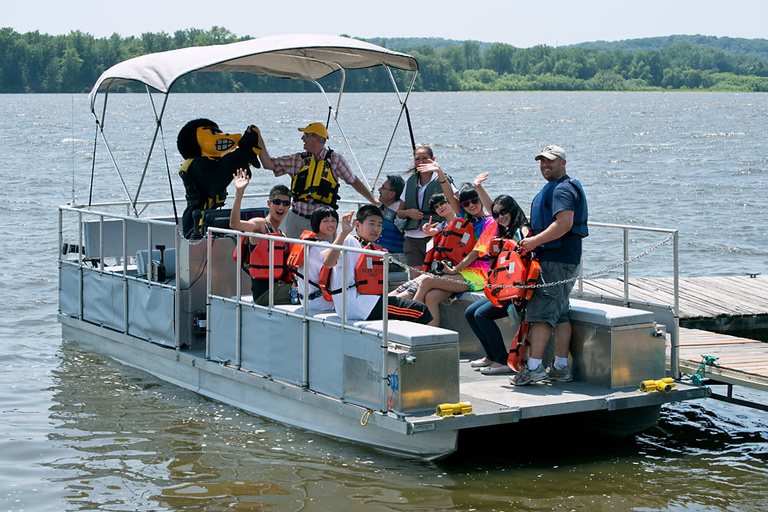 students and researchers and Herky on pontoon