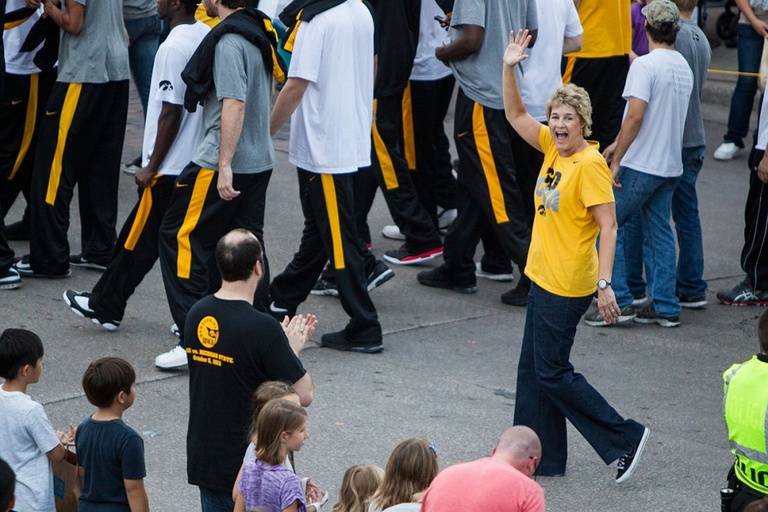A woman waving in a parade