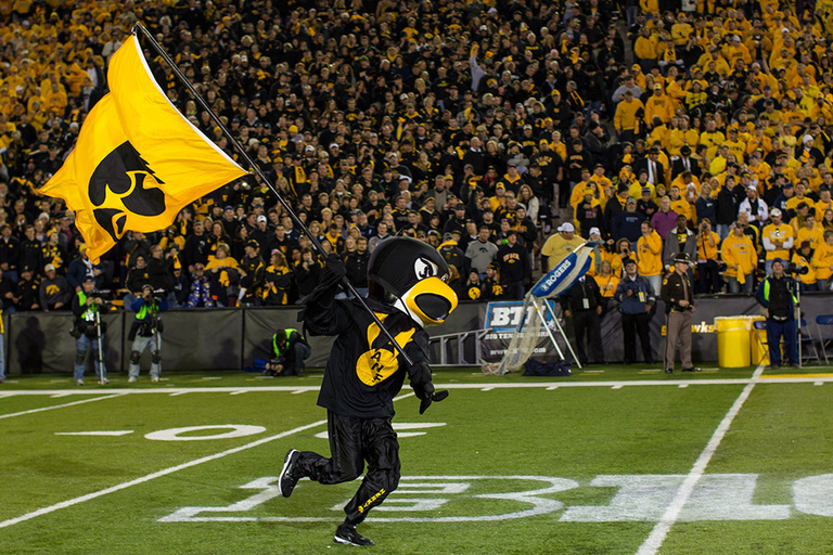Herky runs onto the field in a black outfit.
