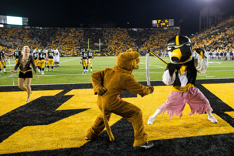 Mascots stage a sword fight in the end zone.