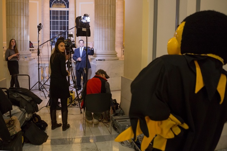 Just outside the Caucus Room, Herky makes friends with a news team about to conduct a live broadcast in the Cannon House Office Building.