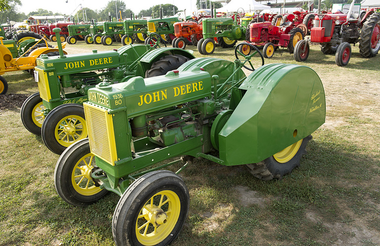 Rows of restored tractors on display.