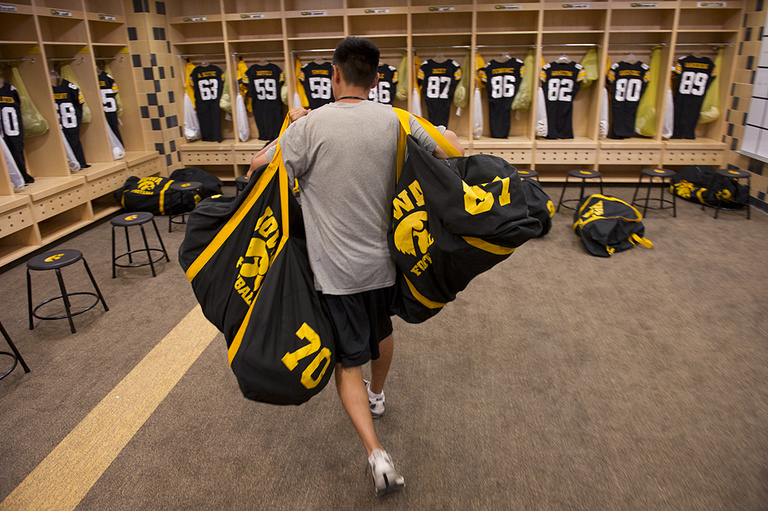 Football gear bags being distributed in the locker room