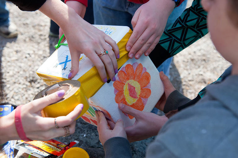 Students tape the package shut just prior to liftoff.