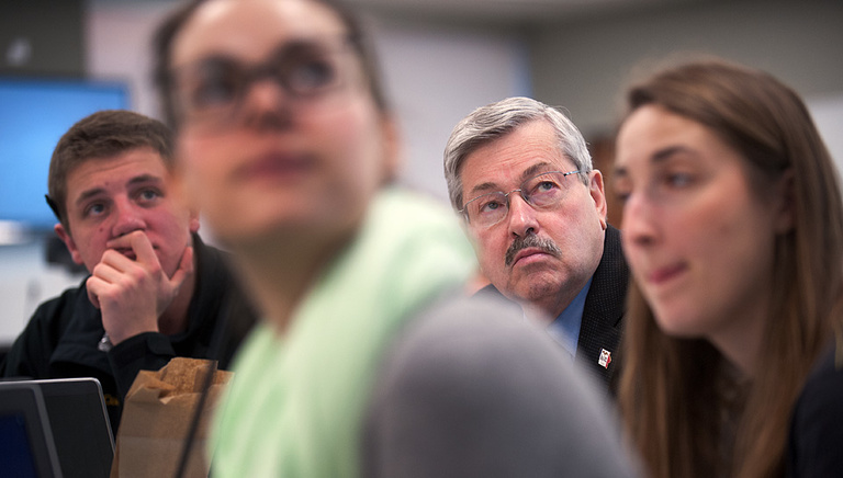 Gov. Branstad and his group of students watch a short presentation.