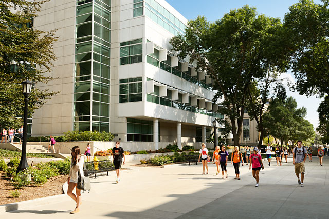 Color photo os students strolling along Cleary Walkway, with the Pomerantz Center in the background