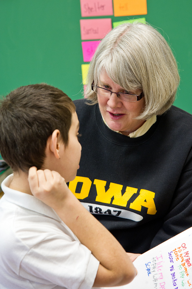 Nita Schmidt, associate professor of teaching and learning in the College of Education, speaks one-on-one with a student at John H. Hamline Elementary Specialty School.
