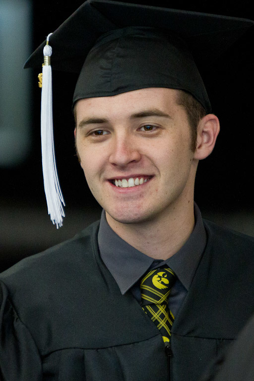Graduate John Mullen in his cap and gown and Tigerhawk tie